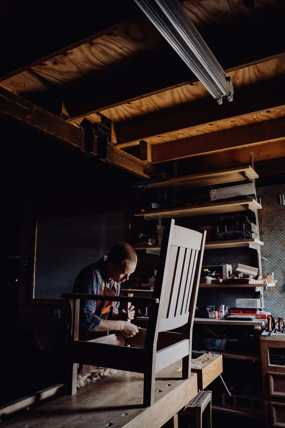 Craftsman working on a chair in a workshop